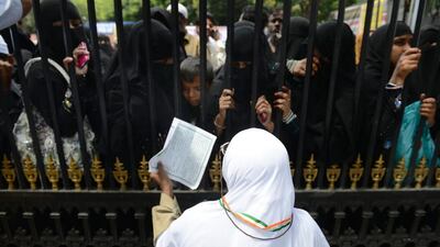 An Indian Muslim pilgrim bids farewell to relatives at Haj House in Hyderabad ahead of departing for Saudi Arabia. Noah Seelam / AFP Photo
