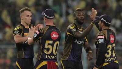 Kolkata Knight Riders' teammates congratulate Tom Curran, left, for the wicket of Delhi Daredevils' Rahul Tewatia. Bikas Das / AP Photo