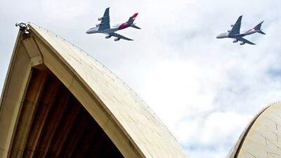 A handout image provided by Qantas shows a Qantas A380 (L) and an Emirates A380 performing a fly-over at more than 450 metres over Sydney Opera House, Australia.