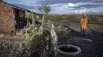 Suwadi (75), stands behind his house that was hit by the by mudflow, suspected to have been triggered by the drilling activities of Lapindo Brantas, although it blames a 6.3 magnitude earthquake that struck a neighbouring area two days befroe. Ulet Ifansasti / Getty Images