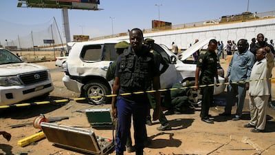 Security personnel stand near a car damaged after an explosion targeting the motorcade of Sudan's Prime Minister Abdallah Hamdok near the Kober Bridge in Khartoum, Sudan. Reuters