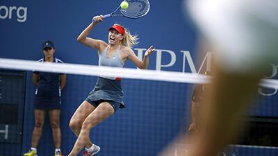 Maria Sharapova returns a shot to Alexandra Dulgheru at the US Open. Jason DeCrow / AP Photo