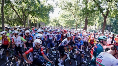 Cyclists waited as Pro-Palestine protesters disrupted the final stage. EPA
