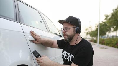Mostyn Rischmueller, aka DJ Megadon Betamax, records car sounds outside his home in Dubai. Sarah Dea / The National