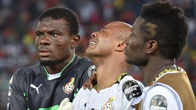 Ghana's Andre Ayew, centre, is comforted by keeper Razak Brimah, left, and Asamoah Gyan, right, after their loss in the Africa Cup of Nations final to Ivory Coast on Sunday. Issouf Sanogo / AFP