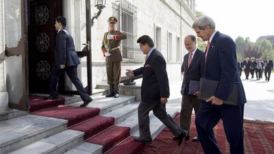 John Kerry (right) arrives for a second meeting with Afghan president Hamid Karzai at the presidential palace in Kabul. Jacquelyn Martin / AP