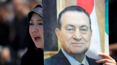 A supporter of Hosni Mubarak demonstrates outside a courtroom in Cairo yesterday. Khalil Hamra / AP Photo