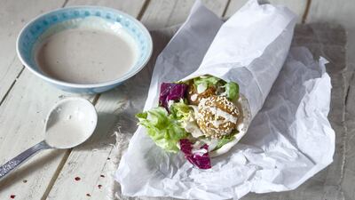 Tahini, a sauce made from sesame seeds, is used as a condiment as well as in dishes such as hummus. Getty Images