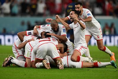Tunisia's team celebrate after scoring what would be the winning goal in their group stage match against France at the Qatar World Cup on November 30, 2022. AFP