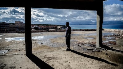 An Afghan man waits to try to cross to the Greek island of Chios, which is becoming an almost impossible dream. Ozan Kose / AFP