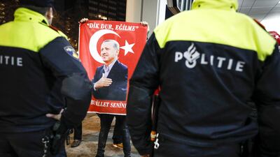 A protester holds a placard with a picture of Turkish president Recep Tayyip Erdogan outside the Turkish consulate in Rotterdam, the Netherlands. Bas Czerwinski / EPA