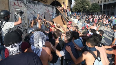 Lebanese anti-government protesters pull a protection wall leading to the Parliament square during a protest in Beirut. EPA