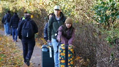 Passengers walk near Gatwick Airport. PA