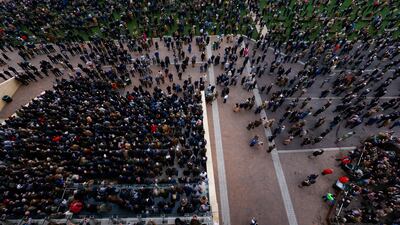 Racegoers in the crowd watch the runners and riders in action. PA
