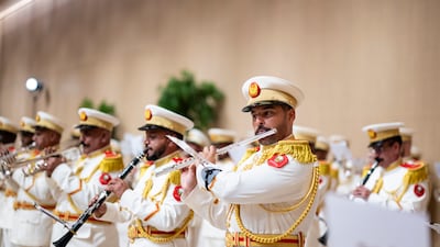 A UAE military band strikes up to welcome Mr Macron to Abu Dhabi. UAE Presidential Court