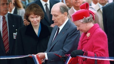 French president François Mitterrand, centre, and Queen Elizabeth II cut a ribbon at the inauguration of the Channel Tunnel in Calais, France on May 6, 1994. Gerard Fouet / AFP