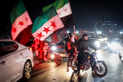 Syrians in Damascus wave the opposition's flag as they celebrate the fall of Bashar Al Assad on December 8, 2024. EPA