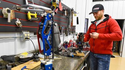 Mike Schultz works on a performance prosthetic for an athlete in his BioDapt, shop in St Cloud, Minnesota. Jason Wachter / St Cloud Times via AP File