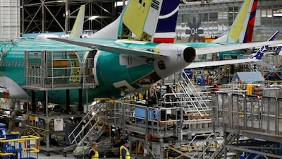 Employees walk by the end of a 737 Max aircraft at the Boeing factory in Renton, Washington. The FAA has identified a new risk that Boeing must address before the plane can return to service. Reuters