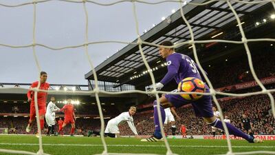 Liverpool’s Roberto Firmino shoots past Watford goalkeeper Costel Pantilimon to score his team’s fourth goal. Paul Ellis / AFP