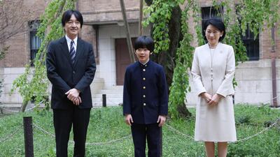 In this file photo taken on April 8, 2019 Japan's Prince Hisahito (C) and his parents Prince Akishino (L) and Princess Kiko (R) pose for photos at Ochanomizu University junior high school before attending the entrance ceremony in Tokyo. AFP