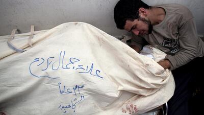 A man mourns over his dead relative at the morgue in Shifa Hospital in Gaza City. Over 50 Palestinians were killed in the Shejaia neighbourhood, which was heavily shelled by Israel during fighting, in Gaza City. Thousands fled for shelter to a hospital packed with wounded, while bodies were unable to be recovered for hours until a brief ceasefire was implemented.