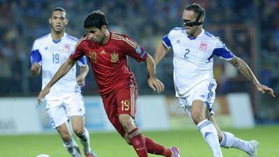 Diego Costa of Spain dribbles around Luxembourg defenders on Sunday night in Spain's 4-0 win in Euro 2016 qualifying in Luxembourg. Eric Vidal / Reuters / October 12, 2014