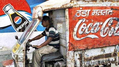 Above, a delivery man in New Delhi. An environment group in 2006 warned of pesticide in soft drinks. Tengku Bahar / AFP