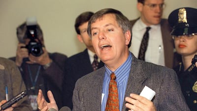 Mr Graham, at the time a US representative, talks to reporters after a meeting of the the 'House Managers', members of the House Judiciary Committe who would serve as prosecutors in the impeachment trial against US president Bill Clinton to be held in the US Senate in early January 1999. AFP
