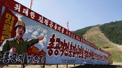 North Korean propaganda that reads, “Full attack. March forward. Let’s absolutely finish building Masik Pass ski resort within this year by launching a full aggressive war and full battle” stands at the base of a ski resort building project at North Korea's Masik Pass. Kim Kwang Hyon / AP