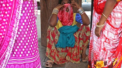 A woman covers her mouth in Bangalore, India, on April 7, 2021. The country recorded 115,736 new coronavirus cases in the latest 24-hour reporting period, the highest daily figure since the start of the pandemic. A second wave of Covid-19 in India has led several states, including Maharashtra and the capital, New Delhi, to reimpose restrictions. EPA