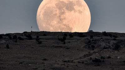 The waxing gibbous moon rises in the countryside of the village of Tal Sallur in the rebel-held Afrin region of Syria's northern Aleppo province a day ahead of the June "strawberry supermoon". AFP