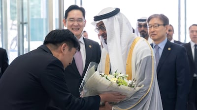 Sheikh Mohamed bin Zayed is presented with flowers upon his arrival.