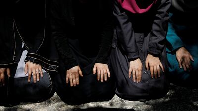 Palestinians pray at an entrance to the compound known to Muslims as Noble Sanctuary and to Jews as Temple Mount in Jerusalem's Old City. Ammar Awad / Reuters