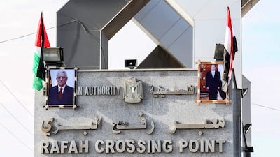 Portraits of Egyptian president Abdel Fattah Al Sisi and Palestinian leader Mahmoud Abbas hang at the Rafah border crossing with Egypt on November 1, 2017. Hamas handed over control of the Gaza Strip's border with Egypt to the Palestinian Authority today. Said Khatib / AFP