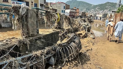 People walk past scattered debris. AFP