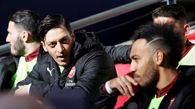 Arsenal's Mesut Ozil and Pierre-Emerick Aubameyang on the bench before the match. Reuters