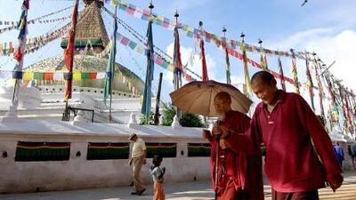 Buddhist monks walk round the base of the Bodhnath Stupa in Kathmandu.