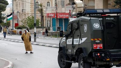 A Palestinian demonstrator stands in front of an Israeli military vehicle during clashes following a protest in the West Bank city of Bethlehem. Mussa Qawasma / Reuters