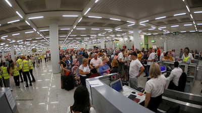 Passengers are seen at Thomas Cook check-in points at Mallorca Airport, Spain. Reuters