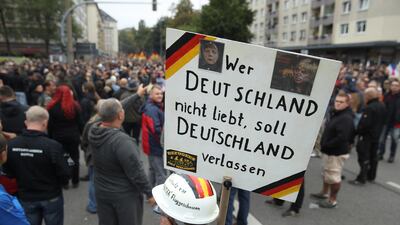 A protester holds a sign that reads: 'Whoever doesn't love Germany should leave Germany' in Chemnitz. Getty Images