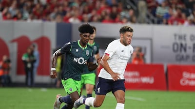 Liverpool's Alex Oxlade-Chamberlain, right, runs past Sporting's Therry Correia. AFP