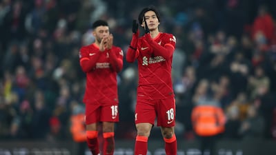 Takumi Minamino of Liverpool applauds fans after the 2-1 FA Cup victory over Norwich at Anfield. Getty