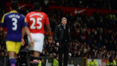 A dejected Moyes heads to the Old Trafford dressing room after seeing his Manchester United side eliminated from the FA Cup third round on Sunday by Premier League rivals Swansea City. Peter Powell / EPA