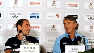 Manchester City manager Roberto Mancini, right, is urging the club's to make new signings.