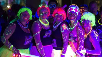 Participants wearing neon-coloured clothes pose for pictures during the 5km Electric Run around Wembley Stadium in London. Justin Tallis / AFP Photo