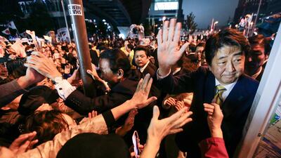 Japanese prime minister Shinzo Abe (right) is crowded by voters along with former prime minister and current finance minister Taro Aso (left) during his final day of campaigning ahead of elections for the lower house of parliament, outside Akihabara JR Station in Tokyo on October 21, 2017. Kimimasa Mayama / EPA