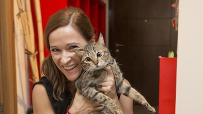Sulafa Tower resident Carla Julian saw firefighters bring birds, dogs and cats to safety. She was at home when the fire started and quickly took her cat, Miss Bradshaw, outside. Antonie Robertson / The National