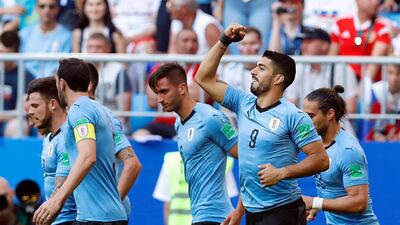 Luis Suarez, second from right, opened the scoring for Uruguay in the 3-0- win over Russia. Hassan Ammar / AP Photo