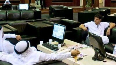 Investors watch the market at the Dubai Financial Market in Dubai / Charles Crowell for The National